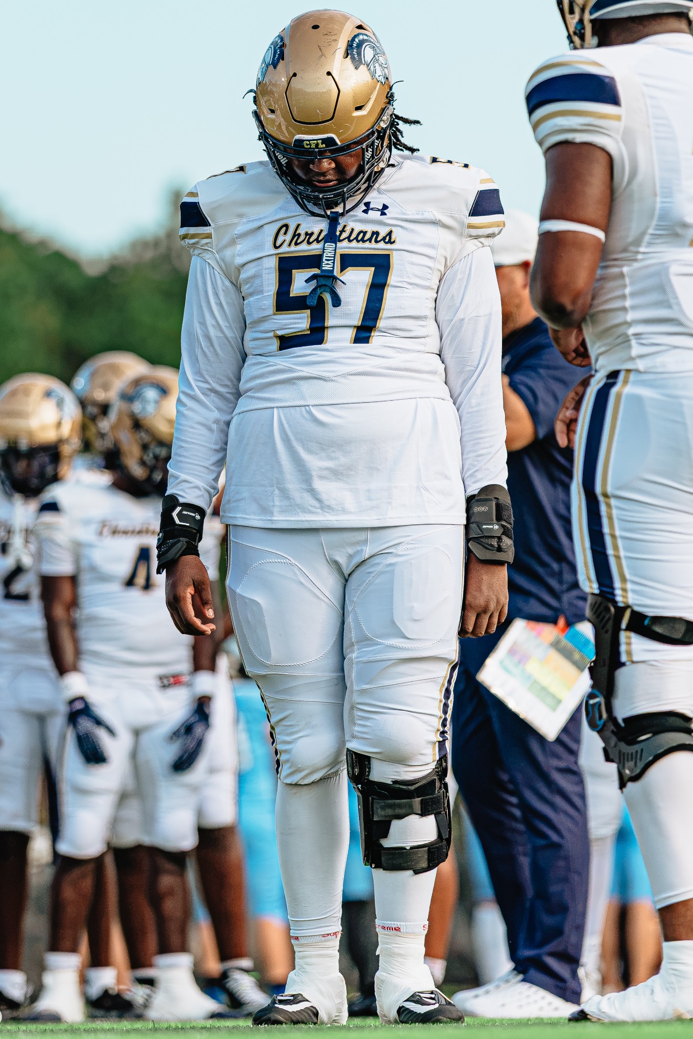 Kayden Hamilton number 57 on the sideline in white uniform